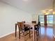 Cozy dining area featuring hardwood floors and access to living room at 1034 Shadowbrook N Dr, Lakeland, FL 33813
