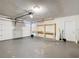 Spacious two car garage with storage, workbench, and white door at 1034 Shadowbrook N Dr, Lakeland, FL 33813