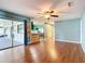 Bright living space with hardwood floors, ceiling fan, and sliding glass door access to patio at 1034 Shadowbrook N Dr, Lakeland, FL 33813