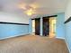 Spacious main bedroom with blue walls, ceiling fan, and decorative barn doors at 1034 Shadowbrook N Dr, Lakeland, FL 33813