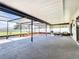 A roomy screened in patio with a seating area and views of the backyard at 1034 Shadowbrook N Dr, Lakeland, FL 33813