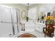 White bathroom featuring glass shower, corner tub, vanity and chandelier at 1117 Stonebrooke Ln # 58, Lakeland, FL 33803