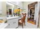 Bathroom with vanity, chair, mirror, and doorway leading to the closet at 1117 Stonebrooke Ln # 58, Lakeland, FL 33803