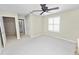 Neutral bedroom featuring a ceiling fan and shuttered windows at 1117 Stonebrooke Ln # 58, Lakeland, FL 33803