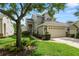 Charming home features a two-car garage, manicured lawn, and mature trees in a well-maintained neighborhood at 1117 Stonebrooke Ln # 58, Lakeland, FL 33803