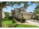 Charming home features a two-car garage, manicured lawn, and mature trees in a well-maintained neighborhood at 1117 Stonebrooke Ln # 58, Lakeland, FL 33803