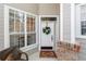 Inviting front door with a wreath, brick accents, a decorative doormat, and a window seat at 1117 Stonebrooke Ln # 58, Lakeland, FL 33803