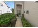 This cozy front porch features brick accents, lush landscaping, and inviting pathway to the entrance at 1117 Stonebrooke Ln # 58, Lakeland, FL 33803