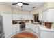 Well-lit kitchen features white cabinets, modern appliances, and functional design with an area rug at 1117 Stonebrooke Ln # 58, Lakeland, FL 33803