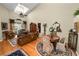 Open-concept living room featuring a vaulted ceiling, hardwood floors, and comfortable seating at 1117 Stonebrooke Ln # 58, Lakeland, FL 33803