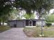 Charming single-story home with a garage, complemented by mature trees and landscaping at 1120 Ivy Ln, Bartow, FL 33830