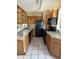 Kitchen featuring wood cabinets, tile flooring and standard appliances at 1120 Ivy Ln, Bartow, FL 33830