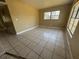 This living room features tile flooring and a window at 1120 Ivy Ln, Bartow, FL 33830