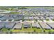 Extensive aerial view of a neighborhood with meticulously maintained lawns and a tranquil lake at 1125 Mattie Pointe Blvd, Auburndale, FL 33823