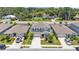Aerial view highlighting a two-story home with a well-maintained lawn and ample parking at 1125 Mattie Pointe Blvd, Auburndale, FL 33823
