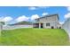 Spacious backyard featuring lush grass, a privacy fence, and a screened-in patio at 1125 Mattie Pointe Blvd, Auburndale, FL 33823
