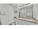 Bright bathroom with double sinks, large mirror, and a shower visible in the mirror's reflection at 1125 Mattie Pointe Blvd, Auburndale, FL 33823