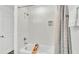 Clean white bathroom features a shower over tub with coordinating shower curtain at 1125 Mattie Pointe Blvd, Auburndale, FL 33823