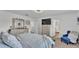 Cozy bedroom features a large bed, dresser, a TV, and an ensuite bathroom for added privacy and convenience at 1125 Mattie Pointe Blvd, Auburndale, FL 33823