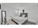 Minimalist bedroom featuring a comfortable bed, dark color accents, and cozy furnishings creating a relaxing retreat at 1125 Mattie Pointe Blvd, Auburndale, FL 33823