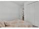 Relaxing bedroom with a comfortable bed and view into the ensuite bathroom and a large closet at 1125 Mattie Pointe Blvd, Auburndale, FL 33823