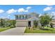Charming two-story home with well-manicured lawn and gray wood facade at 1125 Mattie Pointe Blvd, Auburndale, FL 33823