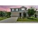 Charming two-story home with a manicured lawn, a two-car garage, and attractive landscaping at 1125 Mattie Pointe Blvd, Auburndale, FL 33823