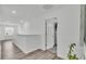 Bright hallway featuring wood-look flooring, white walls, and an open doorway at 1125 Mattie Pointe Blvd, Auburndale, FL 33823
