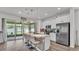 Gourmet kitchen featuring a spacious island with seating and stainless steel appliances at 1125 Mattie Pointe Blvd, Auburndale, FL 33823