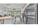 Bright, open kitchen featuring a large island, stainless appliances, and a seamless connection to the backyard at 1125 Mattie Pointe Blvd, Auburndale, FL 33823