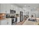Modern kitchen with stainless steel appliances, quartz countertops, and an island with seating at 1125 Mattie Pointe Blvd, Auburndale, FL 33823