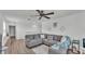 Comfortable living room featuring a gray sectional sofa and ottoman for relaxing with Gathering and friends at 1125 Mattie Pointe Blvd, Auburndale, FL 33823