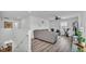Upstairs living room with a gray sofa, a ceiling fan, and views to the dining area below at 1125 Mattie Pointe Blvd, Auburndale, FL 33823