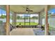 Screened patio with ceiling fan and furniture overlooking the backyard at 1125 Mattie Pointe Blvd, Auburndale, FL 33823