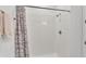 Clean, tiled shower with a shower head and curtain rod, showcasing a functional and modern space at 1125 Mattie Pointe Blvd, Auburndale, FL 33823