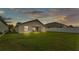 View of the backyard featuring green lawn space with a white fence, and rear exterior of the home at 1129 Bowline St, Winter Haven, FL 33880