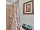 Shower with decorative shower curtain in a well-lit bathroom at 1129 Bowline St, Winter Haven, FL 33880