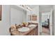 Bathroom featuring double sinks, decorative mirror, and natural light at 1129 Bowline St, Winter Haven, FL 33880