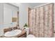 Well-lit bathroom with a shower/tub combo, stylish leaf-patterned shower curtain, and functional vanity at 1129 Bowline St, Winter Haven, FL 33880