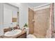 Bright bathroom featuring a shower, a modern vanity, and neutral tile, offering a clean and inviting space at 1129 Bowline St, Winter Haven, FL 33880