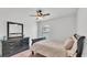 Cozy bedroom featuring a ceiling fan, dresser, and comfortable bed with neutral bedding and natural light at 1129 Bowline St, Winter Haven, FL 33880