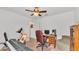 Bedroom featuring a ceiling fan, desk area with computer and a chair with bookcase at 1129 Bowline St, Winter Haven, FL 33880