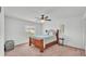 Bedroom featuring wood frame bed, ceiling fan, and natural light from the window at 1129 Bowline St, Winter Haven, FL 33880