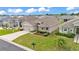 Aerial view of the home features a well-manicured front lawn and a two-car garage at 1129 Bowline St, Winter Haven, FL 33880