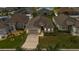 Aerial shot of the home showcasing the landscaped front yard and an attached two-car garage at 1129 Bowline St, Winter Haven, FL 33880