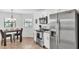 Bright kitchen and dining area featuring stainless steel appliances and modern decor at 1129 Bowline St, Winter Haven, FL 33880