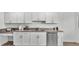 Bright kitchen featuring white cabinets, stainless steel dishwasher, and double basin sink at 1129 Bowline St, Winter Haven, FL 33880