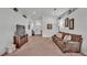 Spacious living room featuring neutral tones, carpeted floors, and stylish decor at 1129 Bowline St, Winter Haven, FL 33880