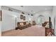 Spacious living room featuring neutral tones, carpeted floors, and access to the backyard at 1129 Bowline St, Winter Haven, FL 33880
