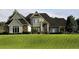 Attractive two-story home featuring stone accents and manicured lawn at 12740 Amber Ave, Clermont, FL 34711